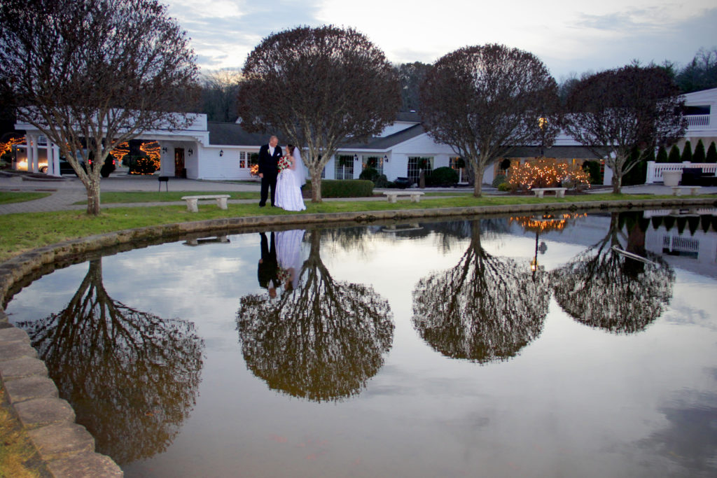 Wedding couple with mirror image on water - White Mountains Wedding Photography